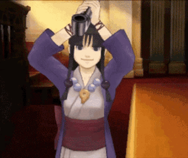 a girl in a purple kimono is holding a gun over her head