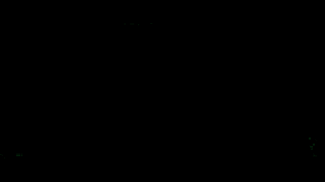 a green light is shining on a black surface in a dark room .