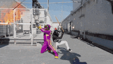 a man in a purple suit is holding a sword