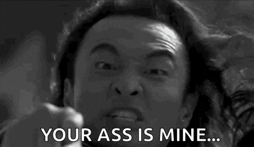 a black and white photo of a man pointing at the camera and saying `` your ass is mine ... ''
