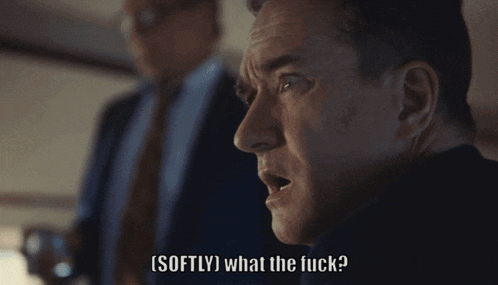 a man in a suit says softly what the fuck in front of another man