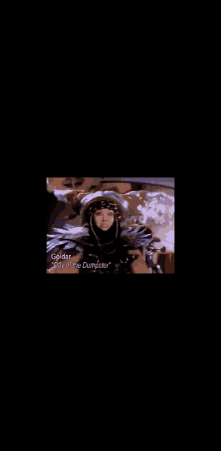 a woman in a helmet and goggles is sitting in a car with the words golday on the bottom right