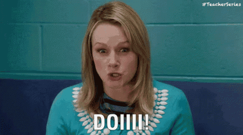 a woman in a blue shirt is making a funny face and saying `` do !!! '' .