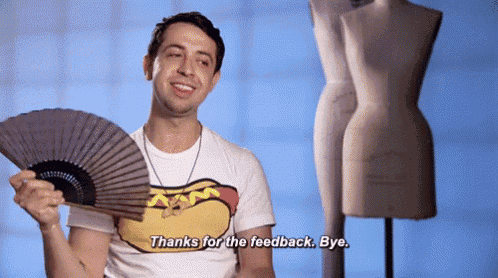a man in a hot dog shirt is holding a fan and saying thanks for the feedback bye .