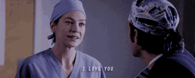 a man and a woman in scrubs are looking at each other and the woman says i love you
