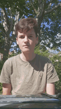 a young man wearing a tommy hilfiger shirt