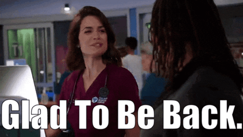 a woman in scrubs is talking to a man with the words glad to be back
