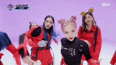 a group of girls are dancing in front of a purple background with mnet written on it