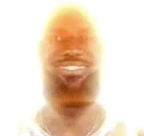 a blurry picture of a man 's face with a beard and a smile .