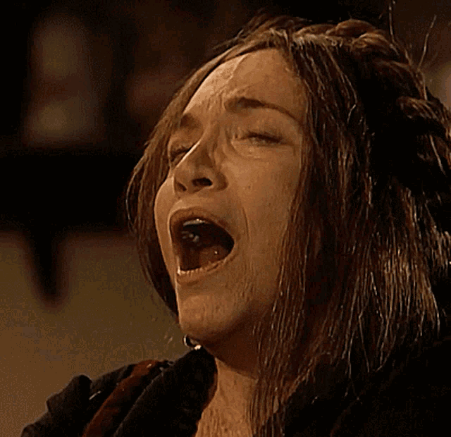 a close up of a woman with her mouth wide open