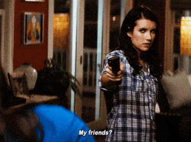 a woman in a plaid shirt is pointing a gun and asking her friends