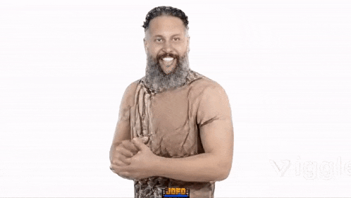 a man with a beard is dressed as a caveman and giving a thumbs up sign .