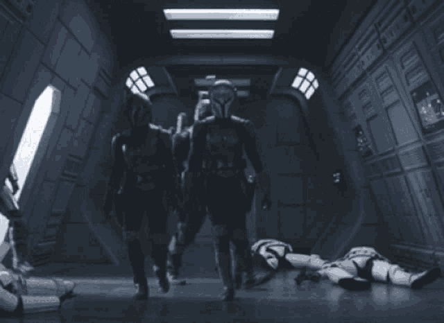 a group of soldiers are standing in a dark hallway