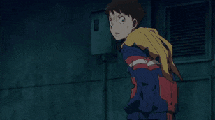a boy in a blue red and yellow jacket is screaming