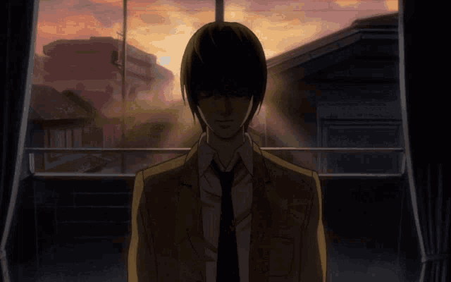 a man in a suit and tie looking out a window