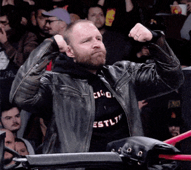 a man wearing a leather jacket and a sweatshirt that says estlin