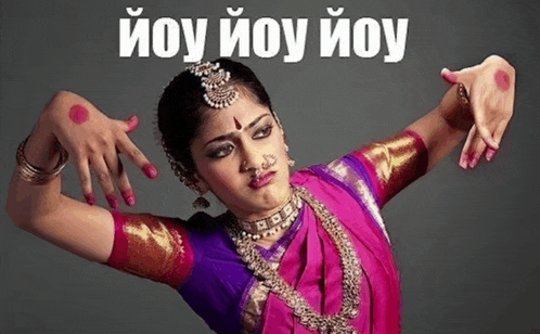 a woman in a pink and purple outfit is dancing in front of a sign that says ioy