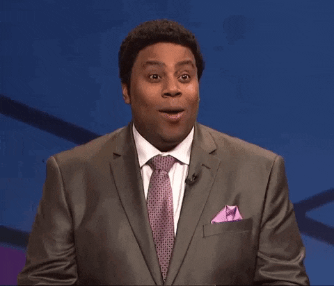 a man in a suit and tie making a funny face