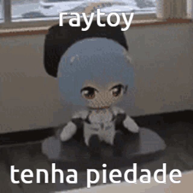 a stuffed toy is sitting on a table next to a window with the words raytoy tenha piedade written on it .