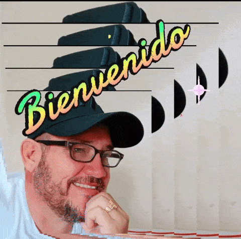 a man wearing glasses and a hat with the word bienvenido on it