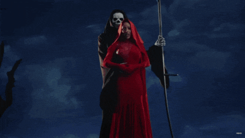 a woman in a red dress is standing next to a grim reaper with a scythe