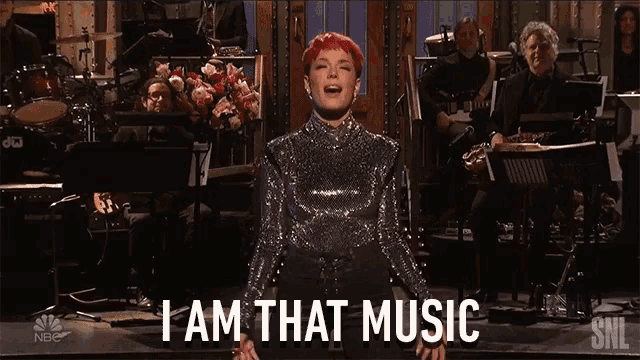 a woman singing on stage with the words " i am that music "