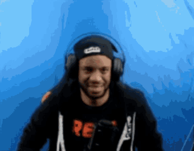 a man wearing headphones and a shirt that says re