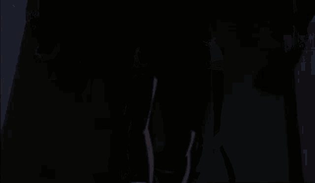 a cartoon character is wearing a black vest and a red button on his back .