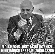 a man in a suit and tie is smelling wheat .