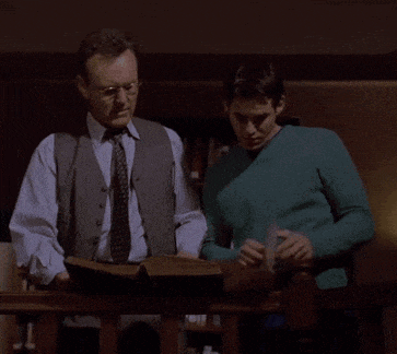 two men looking at a piece of paper with the words we 're going to need a bigger boat below them