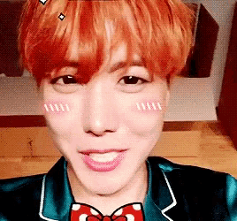 a close up of a person 's face with a bow tie