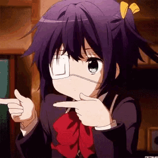 a girl with a bandage on her eye is pointing up