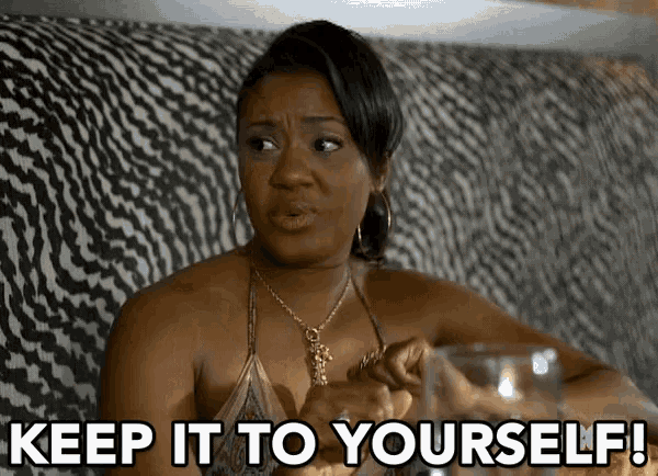 a woman is sitting on a couch holding a glass and says keep it to yourself