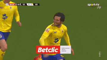 a soccer player is kneeling on the field with a betclic advertisement in the background