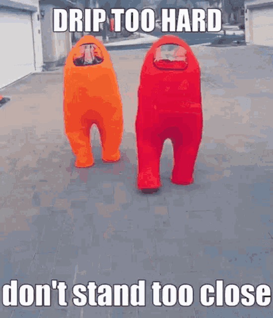 two people in orange and red among us costumes are standing next to each other on a sidewalk .