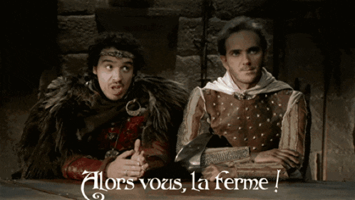 two men sitting at a table with the words alors vous la ferme written on the bottom