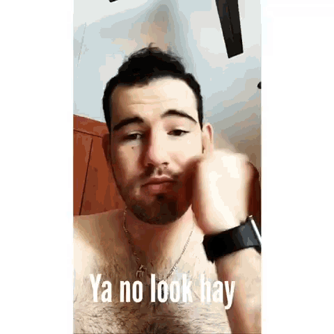 a shirtless man with a beard and a watch is making a funny face .