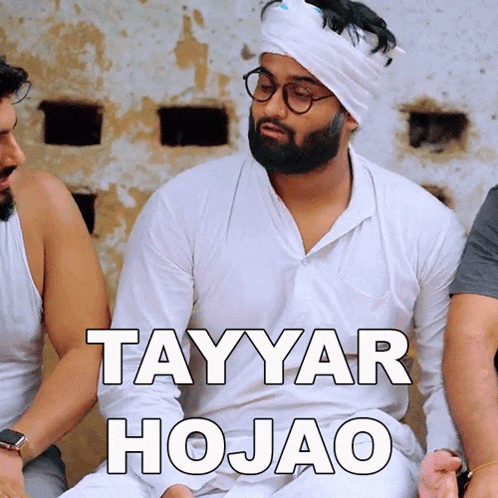 a man with a beard wearing glasses and a turban says tayyar hojao