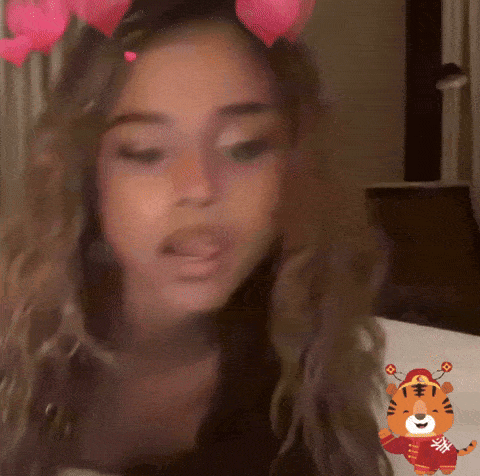 a woman wearing a tiger sticker on her face