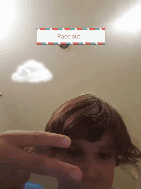 a person taking a picture of a cloud with a sign that says " pace out "