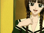 a girl with braids is wearing a green school uniform and smiling .