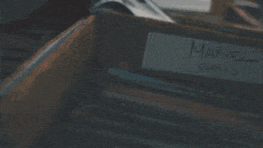 a box labeled spider-man sits in a pile of books