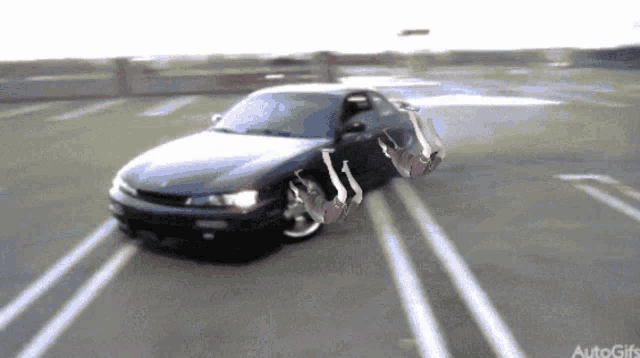 a car is driving down a parking lot with two people falling out of the car