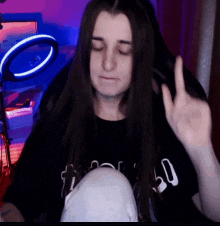 a woman with long hair is wearing a black shirt that says 50 on it .