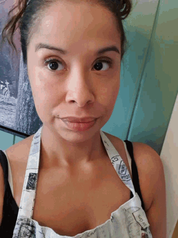 a woman wearing an apron that says ' i love you ' on it