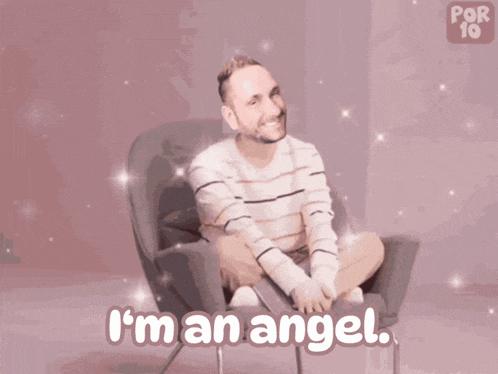a man with angel wings is sitting in a chair and says " i 'm an angel "