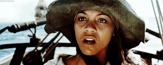 a woman is wearing a pirate hat and making a surprised face
