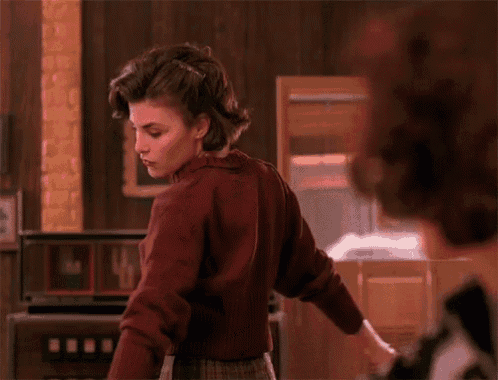 a woman in a red sweater is standing next to a man