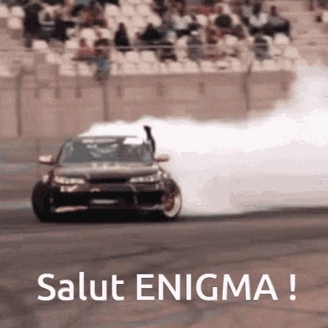 a car is drifting on a race track and salut enigma is written below it