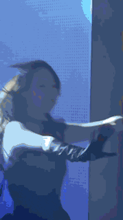 a blurry picture of a woman in a black dress dancing